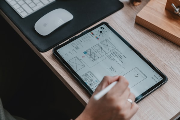 UX designer working with wireframes on a whiteboard